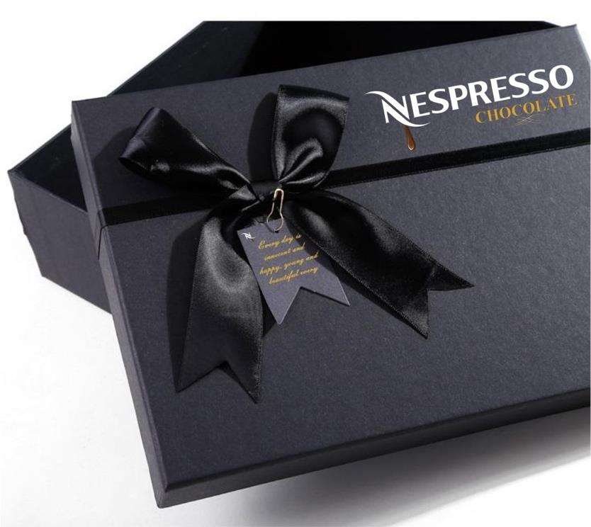 A black Nespresso Chocolate gift box with a black grosgrain ribbon and gold lettering.