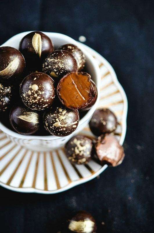 Gold-dusted gourmet chocolate truffles served in a Nespresso cup.